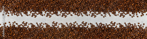Roasted coffee beans background light concrete texture.