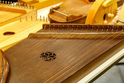 Vintage musical instruments dombra gusli balalaika wooden patterns on the table. photo