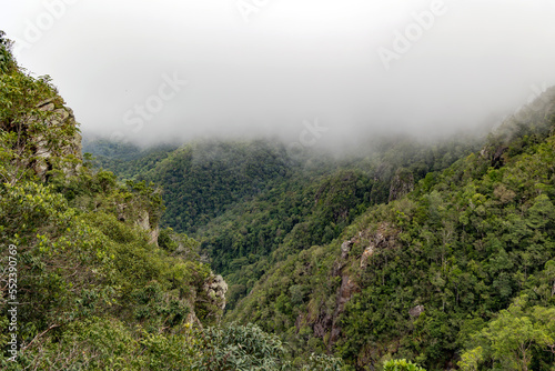 Cincang mountains overgrown with forest in a foggy haze on the ocean shore in Langkawi, Malaysia. Southeast Asia. 