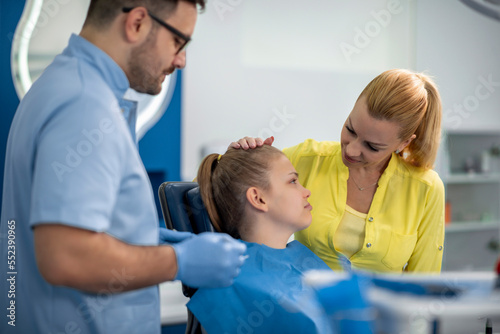 Young girl in stomatology clinic with male dentist