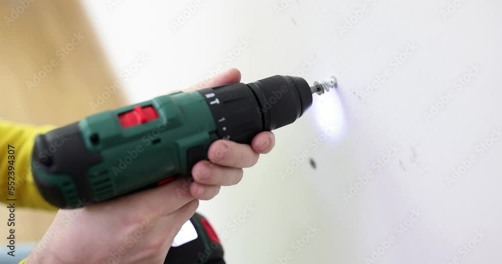 Repairman unscrewing screw from wall with screwdriver closeup 4k movie slow motion Repairman unscrewing screw from wall with screwdriver closeup 4k movie slow motion