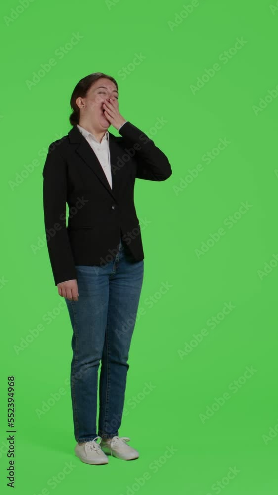 Vertical video: Side view of exhausted businesswoman yawning and feeling sleepy on camera, acting fatigued over greenscreen backdrop. Corporate worker being tired and falling asleep on full body green Vertical video: Side view of exhausted businesswoman yawning and feeling sleepy on camera, acting fatigued over greenscreen backdrop. Corporate worker being tired and falling asleep on full body green