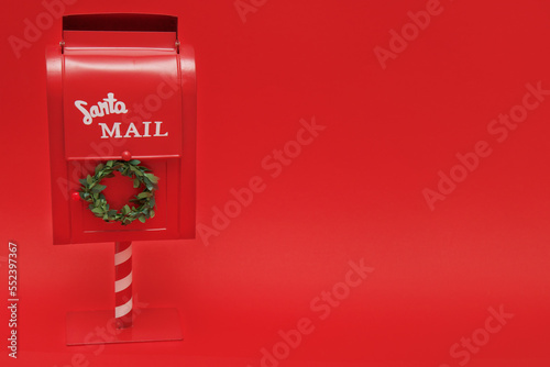 Santa's mailbox on red background with copy space
