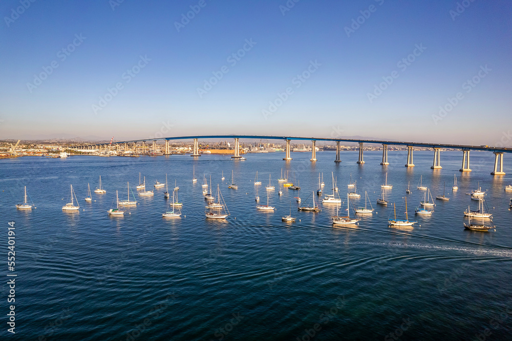 Empty sailboats docked in San Diego bay in front of Coronado Bridge