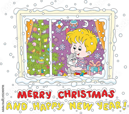 Greeting card with a little boy and his kitten sitting on a windowsill among holiday gifts and sweets and watching merry swirling snowflakes outside a window on a snowy Christmas night