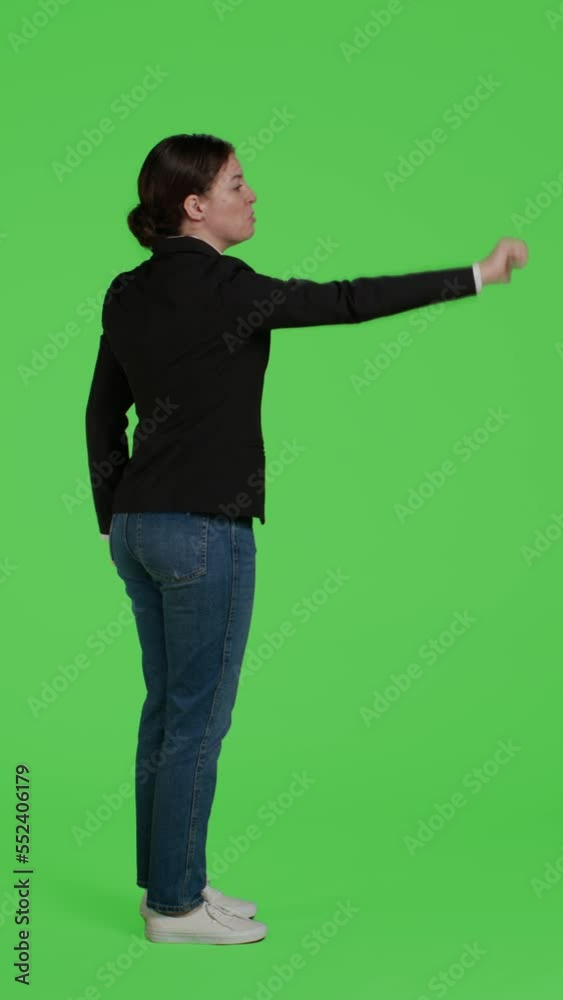 Vertical video: Profile of negative employee showing thumbs down sign in studio, doing dislike and disagreement symbol on camera. Female model expressing disapproval and bad gesture over full body Vertical video: Profile of negative employee showing thumbs down sign in studio, doing dislike and disagreement symbol on camera. Female model expressing disapproval and bad gesture over full body