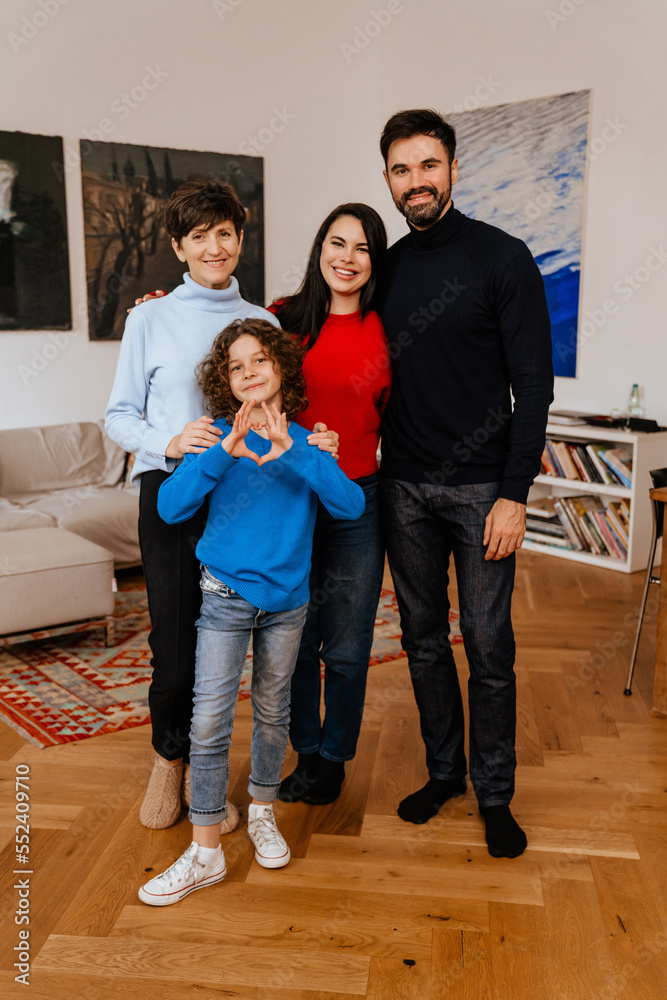 Happy multi generation family standing together at home
