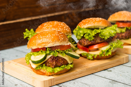 Tasty burgers with steam smoke