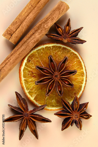 Cinnamon, anise, a slice of dried orange. Top view. Christmas background.