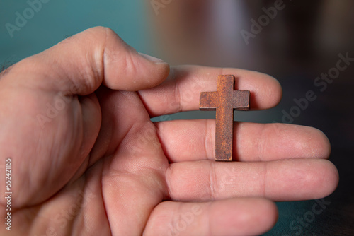 wooden cross in man hand ,close up