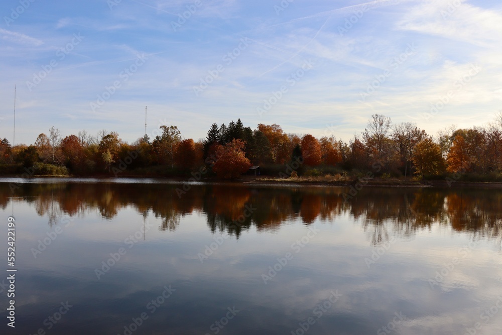 The calm country lake on a sunny autumn morning.
