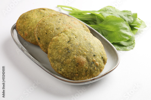 Indian Palak Poori Or Palak Puri Made Of Wheat Flour mixed with blanched Spinach Leaves Served with potato Sabzi Or Veg Curry Sabji.