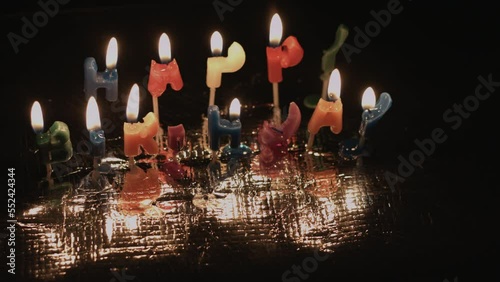 Happy Birthday Candles Burning In Dark with Reflective Silver Yellow Flames 4K photo