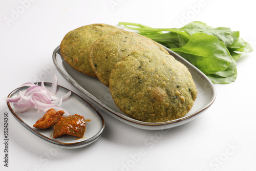 Indian Palak Poori Or Palak Puri Made Of Wheat Flour mixed with blanched Spinach Leaves Served with potato Sabzi Or Veg Curry Sabji.