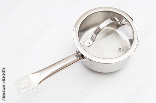 Stainless saucepan with glass lid  on a gray background