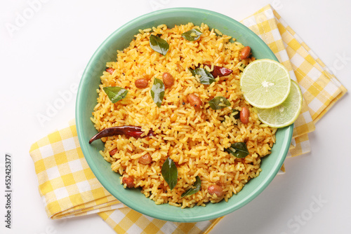 Lemon Rice or fodnicha bhat is South Indian turmeric rice or maharashtrian recipe using leftover rice garnished with nuts curry leaves and lemon juice