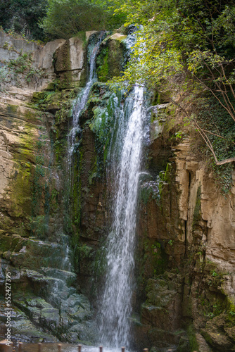 blue waterfall in Tbilisi green trees and bridge