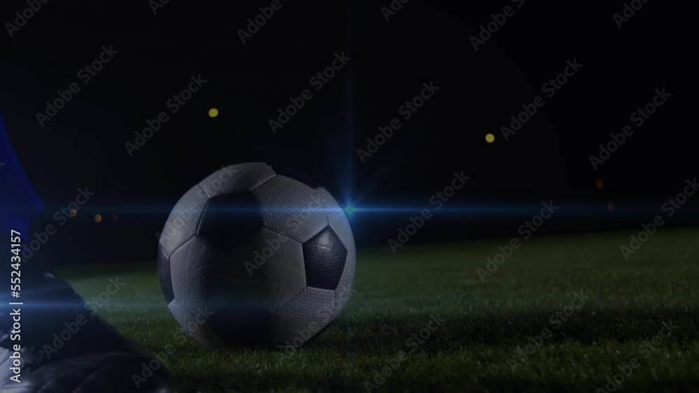 Animation of blue light spot of low section of male soccer player kicking the ball