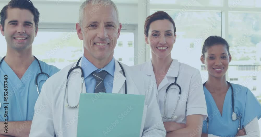 Animation of world cancer day text over caucasian doctors smiling Animation of world cancer day text over caucasian doctors smiling