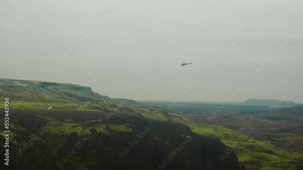 flying helicopter at Haifoss waterfall flying helicopter at Haifoss waterfall