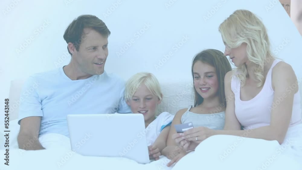 Video of couple with son and daughter paying online with credit card using laptop Video of couple with son and daughter paying online with credit card using laptop