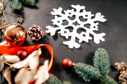 Christmas holiday background with decorations and fir tree. Paper snowflake. 