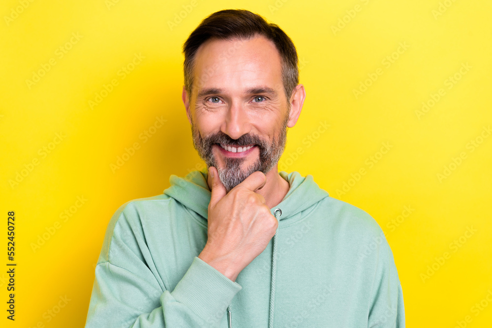 Closeup portrait of intelligent smart businessman mature age brunet hair touch chin smiling posing model isolated on yellow color background