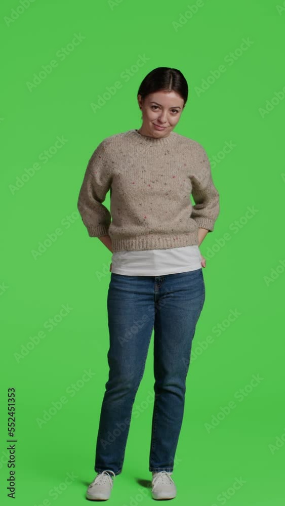 Vertical video: Front view of model standing casual and impatient on camera, posing on greenscreen background. Young woman over isolated green screen backdrop, being thoughtful and waiting, full body. Vertical video: Front view of model standing casual and impatient on camera, posing on greenscreen background. Young woman over isolated green screen backdrop, being thoughtful and waiting, full body.