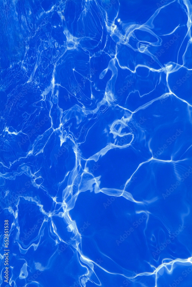 Sunlight shining on a blue swimming pool Sunlight shining on a blue swimming pool