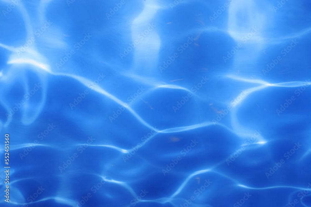 Sunlight shining on a blue swimming pool Sunlight shining on a blue swimming pool