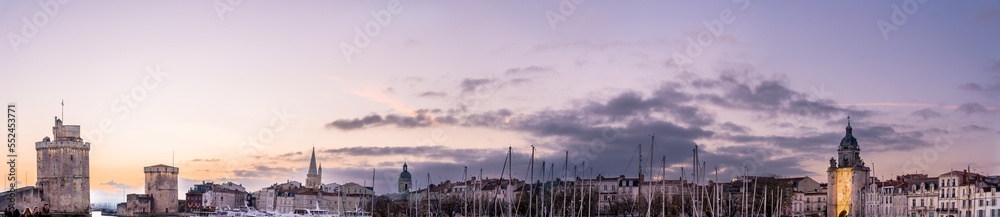 La rochelle harbor at sunset. Panorama skyline. the famous towers of La Rochelle are illuminated with christmas light. banner with copy space