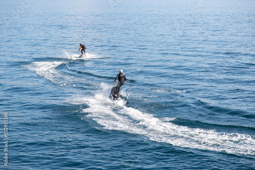 Photography Two men ride on an electric surfboard
