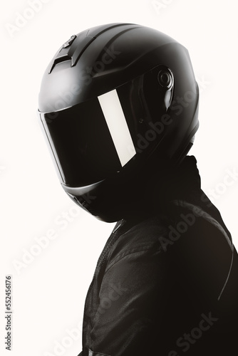Obraz na plátně Portrait of a motorcycle rider posing with a black helmet on a white background