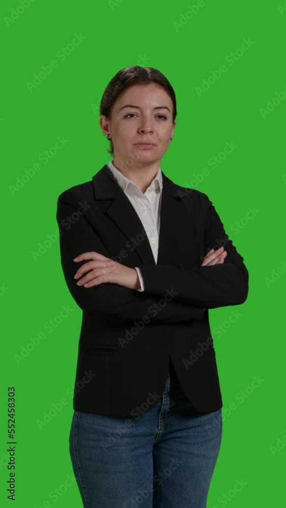 Vertical video: Front view close up of female manager wearing office suit in studio, acting stylish and confident on camera. Businesswoman with corporate job standing over isolated greenscreen Vertical video: Front view close up of female manager wearing office suit in studio, acting stylish and confident on camera. Businesswoman with corporate job standing over isolated greenscreen