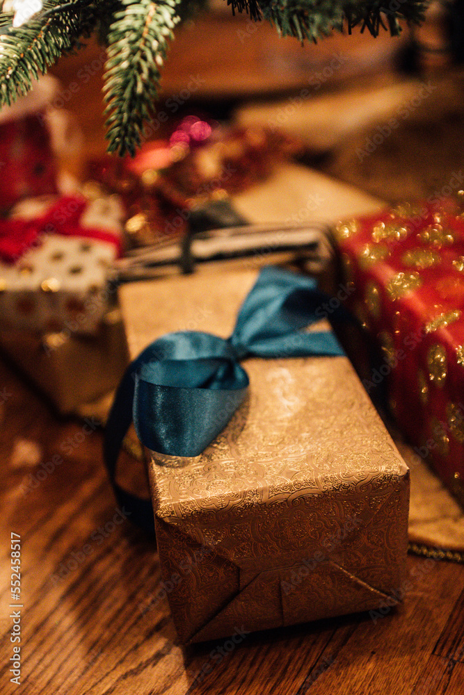 wrapped gold, red, blue presents under the Christmas tree