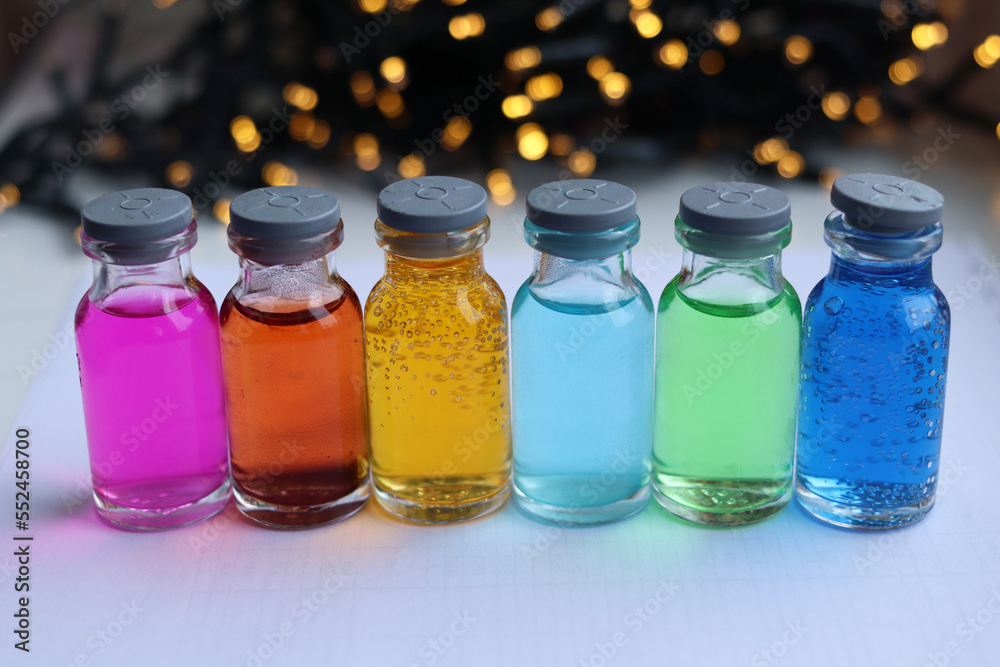 A set of alcoholic solutions of multi-colored indicator dyes in small glass jars. A set of alcoholic solutions of multi-colored indicator dyes in small glass jars.