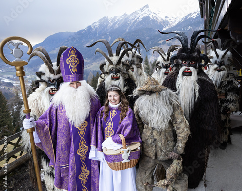 Costumed procession of St. Nicholas, an angel and kramus in a mountainous region, Austria, Salzburg photo