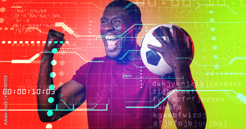 African american male soccer player screaming over illuminated computer language, dots, lines