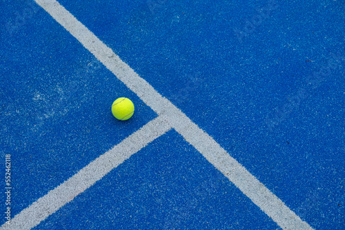 a ball on a blue paddle tennis court where the lines meet © Vic