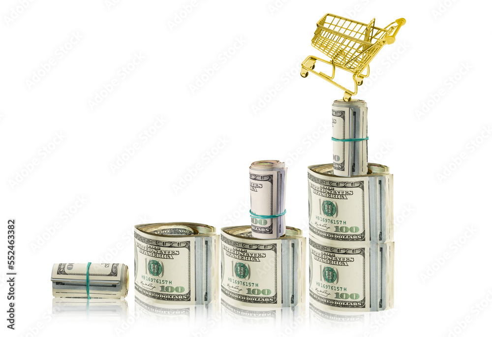 Banknoty dolarowe przypominające wykres inflacji. Na szczycie stoi złoty koszyk sklepowy, wskazujący na wzrost cen. - obrazy, fototapety, plakaty 