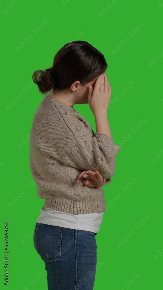 Vertical video: Profile close up of adult dealing with painful headache on camera, rubbing temples to cure sickness. Person suffering from migraine over isolated green screen backdrop, unwell ill Vertical video: Profile close up of adult dealing with painful headache on camera, rubbing temples to cure sickness. Person suffering from migraine over isolated green screen backdrop, unwell ill
