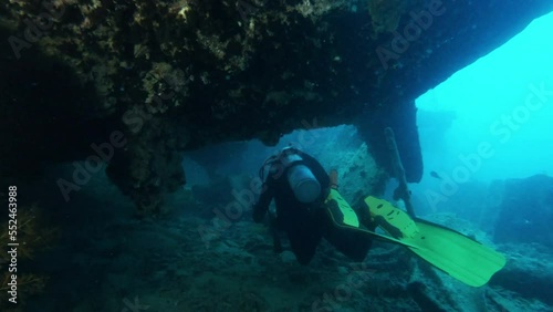 Wallpaper Mural Diver exploring sunken ship underwater, shining with flashlight, back view tracking shot. Ocean bottom scuba diving, old vessel wreck undersea Torontodigital.ca