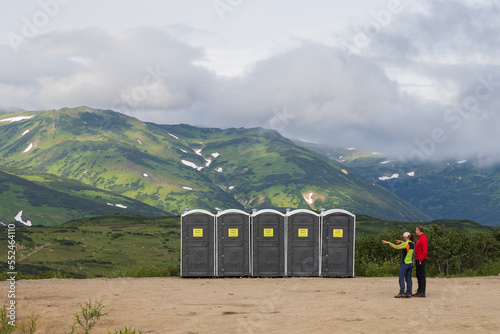 Plastic toilet cubicles in the mountains. Recreation area on a mountain pass. Tourist infrastructure. Travel and tourism on the Kamchatka Peninsula. Kamchatka Krai, Far East of Russia. photo