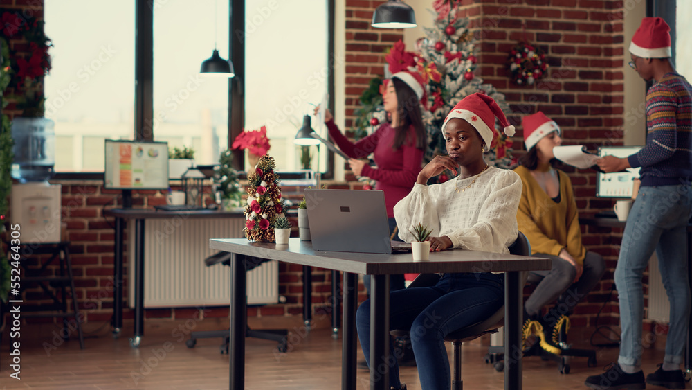 Office employees working on laptop in festive space, doing research data before celebrating christmas eve on fast forward speed. People using computer in office with xmas decor. Timelapse. Office employees working on laptop in festive space, doing research data before celebrating christmas eve on fast forward speed. People using computer in office with xmas decor. Timelapse.