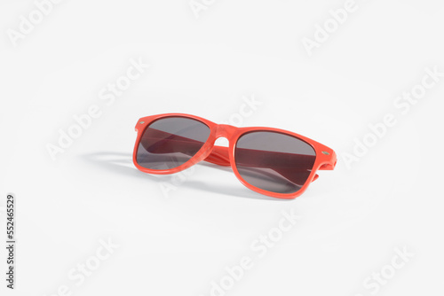 Red sunglasses on white background