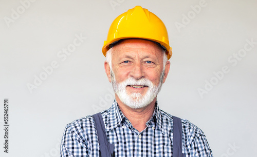 Senior man blue collar worker working in the factory