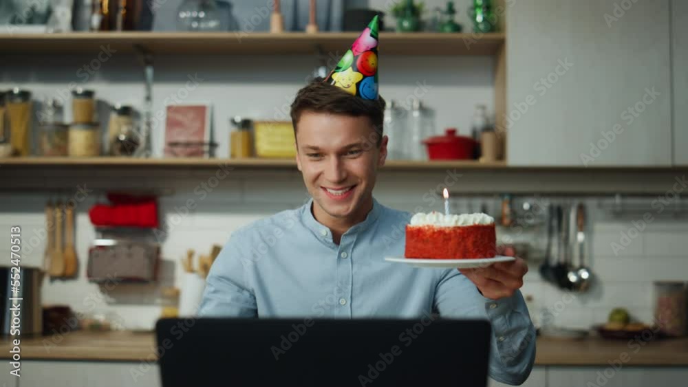 Man enjoy virtual birthday holding cake blowing candle closeup. Guy celebrating.