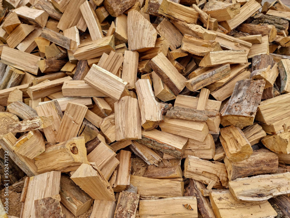 Chopped down tree trunks, firewood stacked in a storage yard, for heating in winter. Selective focus Chopped down tree trunks, firewood stacked in a storage yard, for heating in winter. Selective focus