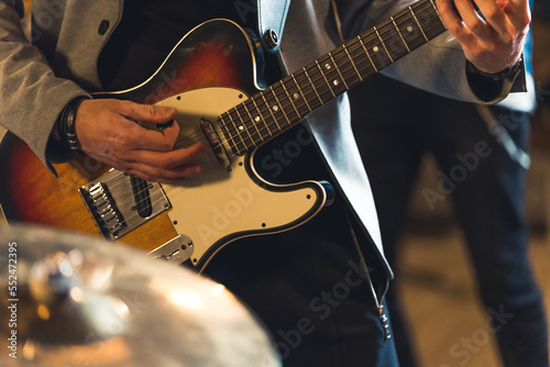 Close up of man playing electric guitar. High quality photo