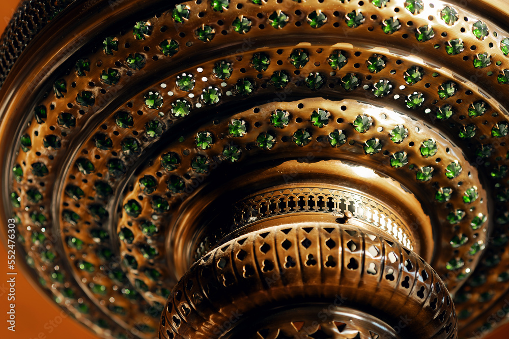 Closeup Antique bronze lamp in Arabic Turkish style with green stones and ornaments